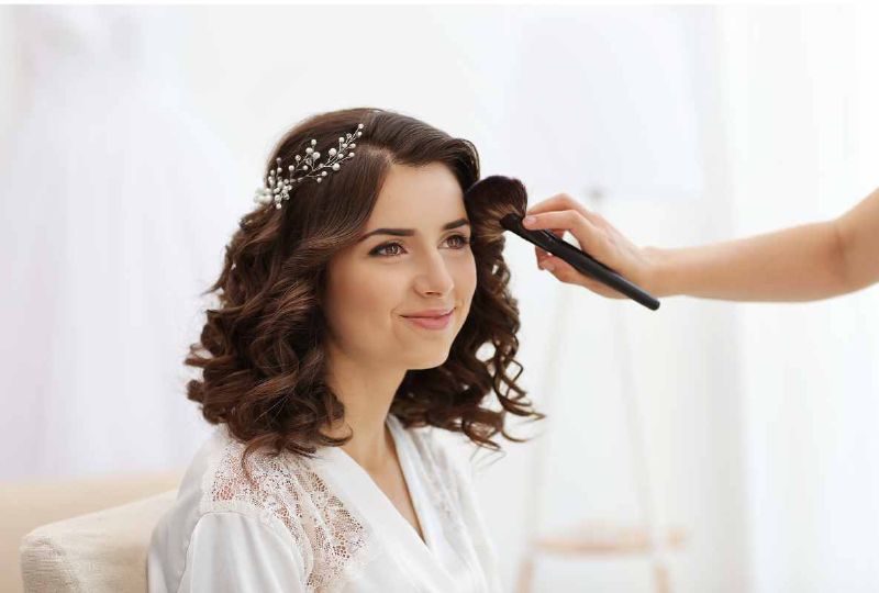 Makeup artist providing touch-up support at a wedding — keeping the bridal look fresh