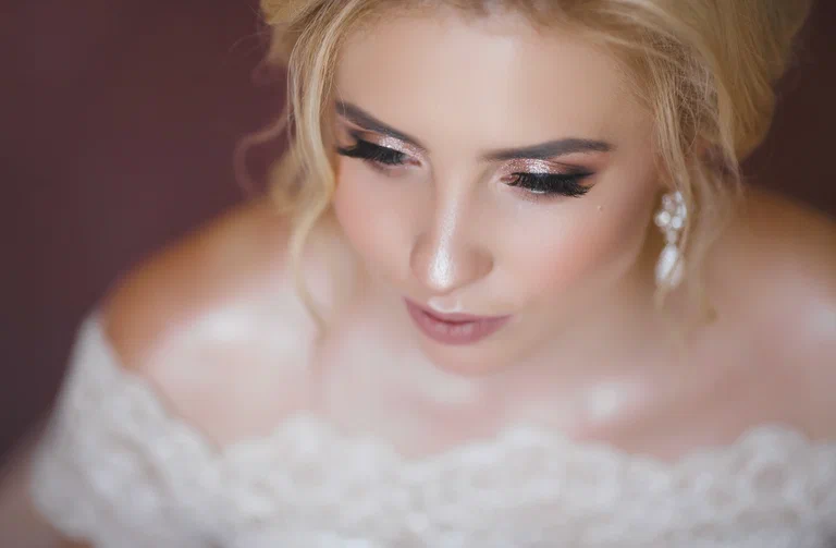 Wedding makeup — bridal close-up with rose shimmer and long lashes