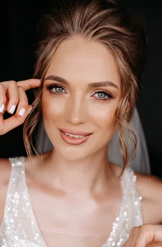 Wedding makeup — refined bridal portrait with champagne rose eyeshadow and lace