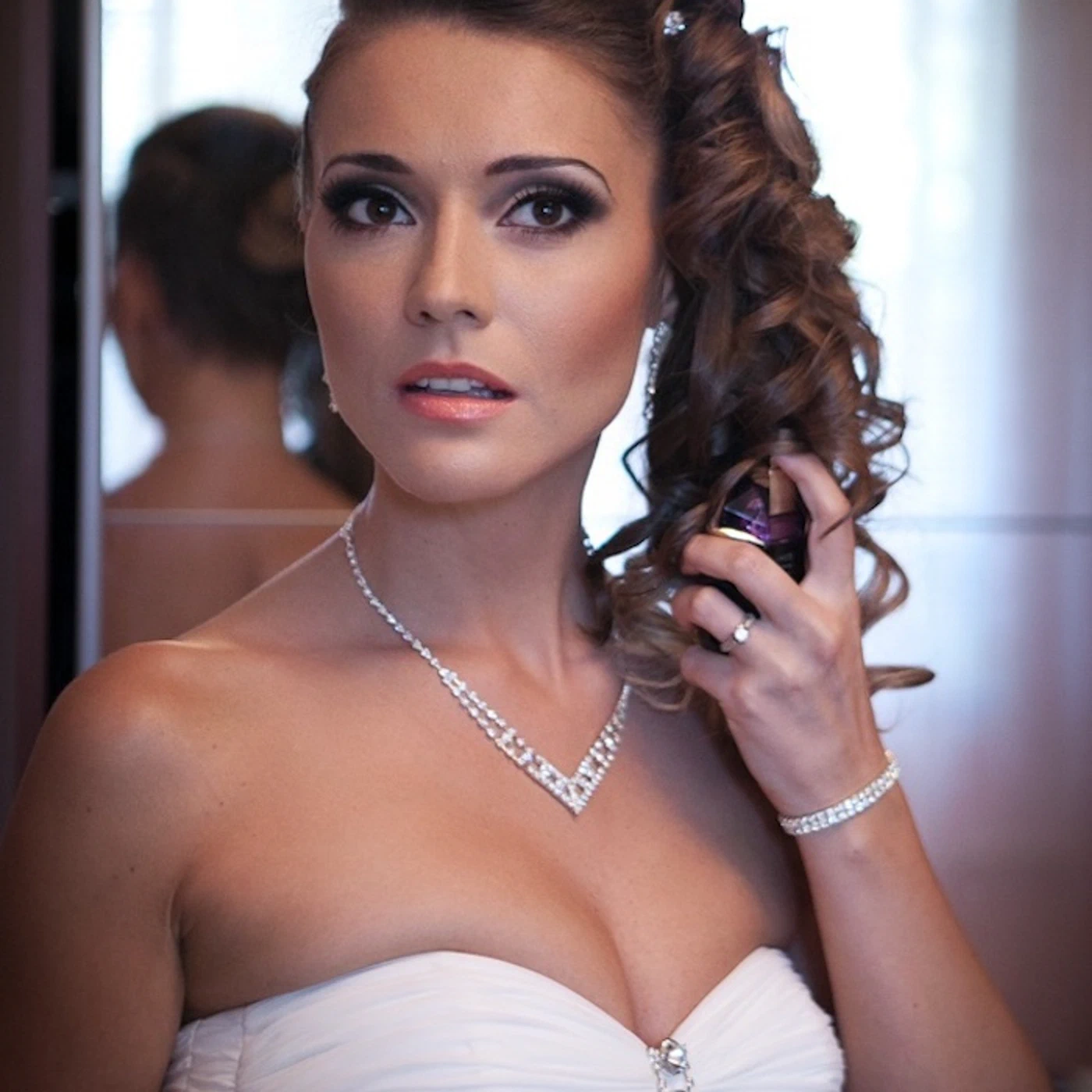 Wedding makeup — glamorous bridal portrait with curls and diamond necklace
